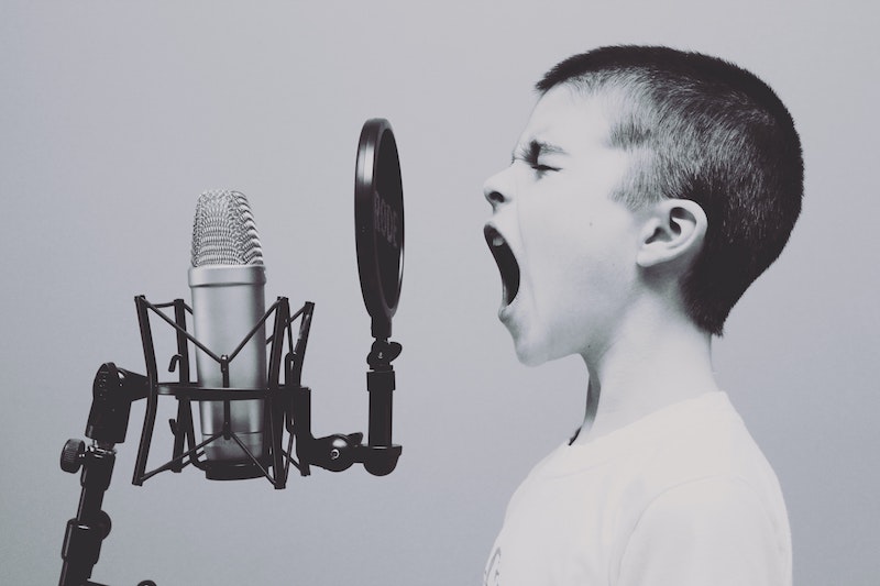 Photo - Boy singing into microphone